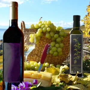 Vino, formaggio, olio d'oliva e uva su tavolo.